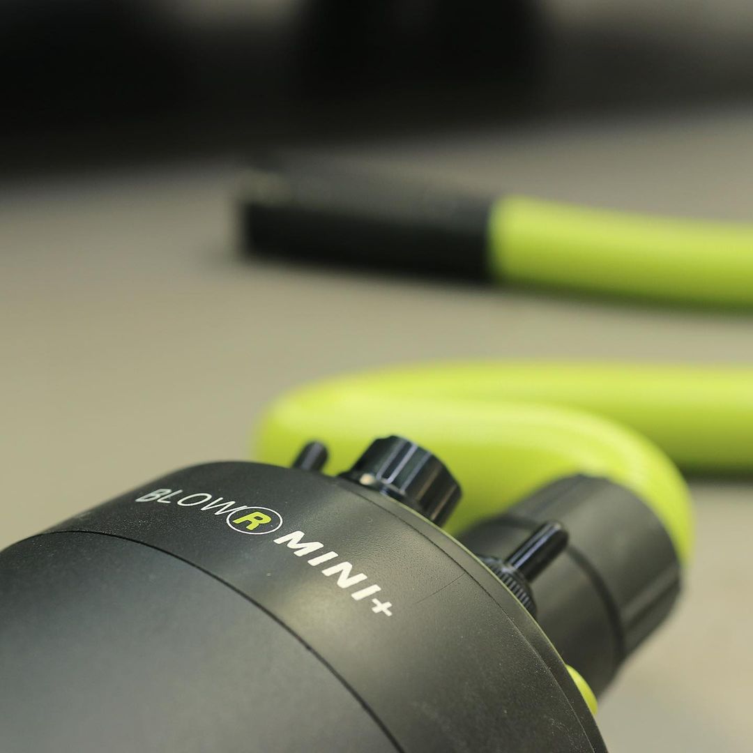 Close-up of BlowR MINI+ car dryer showing dual motor design and nozzle for precision touchless detailing